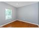 This bedroom features wood floors, neutral walls, and a window offering plenty of natural light at 10725 Tedder Lake Dr, Indianapolis, IN 46239
