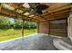Covered patio with rustic wood ceiling and fan, offering a relaxing outdoor space at 10725 Tedder Lake Dr, Indianapolis, IN 46239