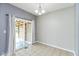 Bright dining area features tile floors, sliding glass doors to deck, and modern lighting at 10725 Tedder Lake Dr, Indianapolis, IN 46239
