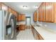Modern kitchen with stainless steel refrigerator, and lots of beautiful wood cabinets at 10725 Tedder Lake Dr, Indianapolis, IN 46239