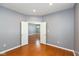 Bright living room boasts wood floors, neutral walls, and an open doorway leading to other living spaces at 10725 Tedder Lake Dr, Indianapolis, IN 46239