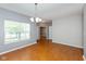 Bright living room boasts wood floors, neutral walls, and ample natural light from a large window at 10725 Tedder Lake Dr, Indianapolis, IN 46239