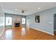 Spacious living room featuring a fireplace, ceiling fan, and ample natural light at 10725 Tedder Lake Dr, Indianapolis, IN 46239