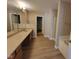 Bathroom featuring double vanity, tub, and walk-in shower at 11070 Long Lake Ln, Fishers, IN 46037