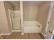 A bathroom with a combination shower and tub with a glass door, and neutral walls at 11070 Long Lake Ln, Fishers, IN 46037
