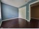 Bedroom featuring hardwood floors and a closet with double doors at 11070 Long Lake Ln, Fishers, IN 46037