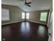 Large bedroom with hardwood floors and multiple windows at 11070 Long Lake Ln, Fishers, IN 46037