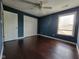 Bedroom featuring hardwood floors, a ceiling fan, and a closet with double doors at 11070 Long Lake Ln, Fishers, IN 46037