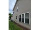 A home's exterior displays vinyl siding, multiple windows, and a well-kept lawn with mulched flower beds at 11070 Long Lake Ln, Fishers, IN 46037