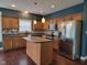 Bright kitchen featuring stainless steel appliances, central island, and hardwood floors at 11070 Long Lake Ln, Fishers, IN 46037