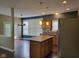 Open-concept kitchen with an island, stainless steel appliances, and hardwood floors at 11070 Long Lake Ln, Fishers, IN 46037