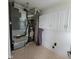 A well-maintained laundry room has white cabinets and beige flooring, equipped with essential appliances at 11070 Long Lake Ln, Fishers, IN 46037