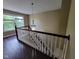 Staircase featuring wood handrail and decorative chandelier at 11070 Long Lake Ln, Fishers, IN 46037