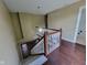 View of staircase with white railings and dark hardwood floors at 11070 Long Lake Ln, Fishers, IN 46037
