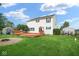 Expansive backyard featuring a deck, lush lawn, storage, and a greenhouse at 11198 N 650 W, Fountaintown, IN 46130