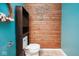 Cozy half bathroom features wood paneled accent wall, turquoise colored walls, and modern fixtures at 11198 N 650 W, Fountaintown, IN 46130