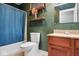 Bathroom with wood vanity, mirror, and dark green painted walls at 11198 N 650 W, Fountaintown, IN 46130