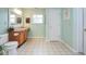 Neutral bathroom with wood vanity, large mirror, and checkered flooring at 11198 N 650 W, Fountaintown, IN 46130