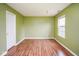 A bright bedroom features laminate flooring, light green paint and a window at 11198 N 650 W, Fountaintown, IN 46130