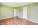 An empty, spacious bedroom with laminate flooring and light green painted walls at 11198 N 650 W, Fountaintown, IN 46130