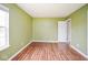 A spacious bedroom with laminate flooring and a light green painted wall at 11198 N 650 W, Fountaintown, IN 46130