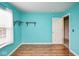 A blue painted bedroom with laminate floors, a window, and wood shelves at 11198 N 650 W, Fountaintown, IN 46130