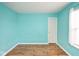An empty bedroom with laminate floors and light blue painted walls at 11198 N 650 W, Fountaintown, IN 46130