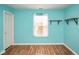 An empty bedroom painted blue with laminate flooring and natural wood shelving at 11198 N 650 W, Fountaintown, IN 46130