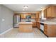 Eat-in kitchen featuring stainless steel refrigerator, kitchen island, and ample counter space at 11198 N 650 W, Fountaintown, IN 46130
