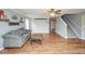 Open living room with hardwood floors, a ceiling fan, and access to the staircase at 11198 N 650 W, Fountaintown, IN 46130