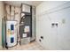 Functional utility room with water heater and storage shelving at 11198 N 650 W, Fountaintown, IN 46130