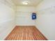 Bright, empty walk-in closet with ample white shelving and wood-look floors at 11198 N 650 W, Fountaintown, IN 46130