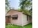 Side view of a one-story home surrounded by mature trees and a well-maintained lawn at 1143 Sharon Ave, Indianapolis, IN 46222