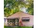 Charming one-story house with mature trees and awning covered porch and windows at 1143 Sharon Ave, Indianapolis, IN 46222