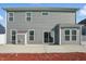 Exterior rear view of a two story home with gray siding and a concrete patio at 1221 Hamilton Dr, Greenwood, IN 46143