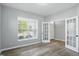 Neutral bedroom featuring an open doorway and a bright window with modern blinds at 1221 Hamilton Dr, Greenwood, IN 46143