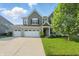 Charming two-story home featuring a three-car garage and well-maintained lawn at 1221 Hamilton Dr, Greenwood, IN 46143