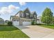 Charming two-story home featuring a three-car garage and well-maintained lawn at 1221 Hamilton Dr, Greenwood, IN 46143