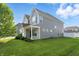 Side view of a gray two-story home with a well-manicured lawn and tasteful landscaping at 1221 Hamilton Dr, Greenwood, IN 46143