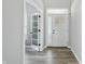 Bright foyer with hardwood floors, a white front door, and an open doorway at 1221 Hamilton Dr, Greenwood, IN 46143