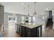Spacious kitchen featuring an island with granite countertops, stainless steel appliances, and access to the living area at 1221 Hamilton Dr, Greenwood, IN 46143