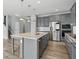 Well-lit kitchen features gray cabinets, a center island with countertops, and stainless steel appliances at 1221 Hamilton Dr, Greenwood, IN 46143