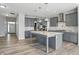 Modern kitchen features gray cabinets, a center island with countertops, and stainless steel appliances at 1221 Hamilton Dr, Greenwood, IN 46143