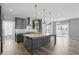 Modern kitchen features gray cabinets, a center island with countertops, and stainless steel appliances at 1221 Hamilton Dr, Greenwood, IN 46143
