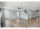 Bright living room showcasing sleek flooring, ceiling fan, and large windows filling the space with natural light at 1221 Hamilton Dr, Greenwood, IN 46143