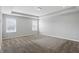 Serene main bedroom with plush carpeting, recessed lighting, tray ceiling, and large windows providing ample natural light at 1221 Hamilton Dr, Greenwood, IN 46143