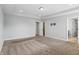 Well-lit main bedroom featuring tray ceiling, plush carpet, and pre-wired television mount offering comfort and modern convenience at 1221 Hamilton Dr, Greenwood, IN 46143