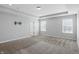 Main bedroom with tray ceiling, recessed lighting, plush carpeting, pre-wired television mount, and two large windows at 1221 Hamilton Dr, Greenwood, IN 46143