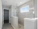 Detailed shot of the main bathroom's tile shower with frameless glass door and a convenient built-in shower seat at 1221 Hamilton Dr, Greenwood, IN 46143