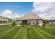 Large backyard area featuring a lush green lawn, brick house, and a relaxing patio for outdoor living at 1227 Highbury Dr, Danville, IN 46122